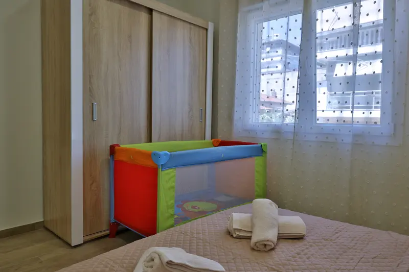Bedroom with a travel cot for the baby